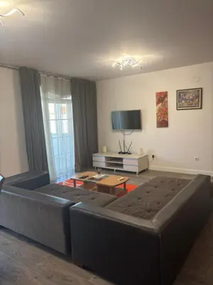 a living room with a couch and a tv at Apartman Popovic 2 in Ub