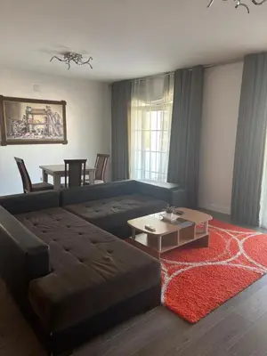 a living room with a couch and a table at Apartman Popovic 2 in Ub