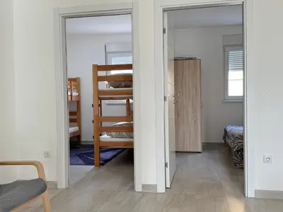 a room with a door open to a bedroom at Belgrade Airport single bed in Surčin