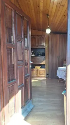 an open door in a room with a kitchen at Wooden house Ada in Ada Ciganlija