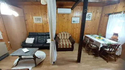 a living room with a couch and a table at Wooden house Ada in Ada Ciganlija