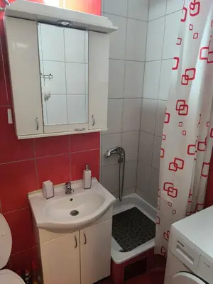 a bathroom with a sink and a shower at R & P Apartman Mladenovac in Mladenovac