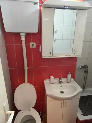 a small bathroom with a toilet and a sink at R & P Apartman Mladenovac in Mladenovac