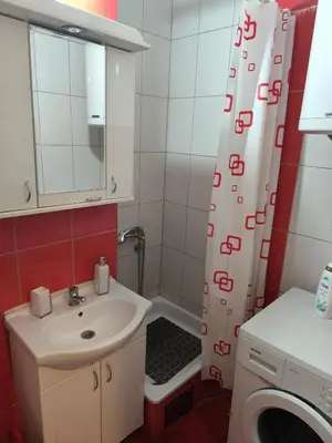 a bathroom with a sink and a shower curtain at R & P Apartman Mladenovac in Mladenovac