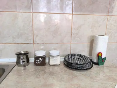 a kitchen counter top with a sink and utensils at R & P Apartman Mladenovac in Mladenovac