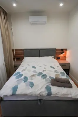 a bedroom with a bed with blue flowers on it at Stan na dan Bulevar in Belgrade