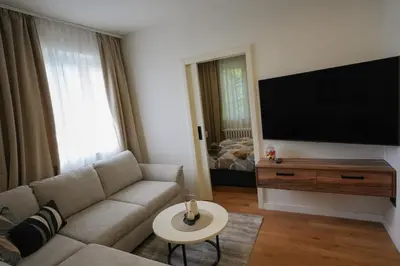 a living room with a couch and a flat screen tv at Stan na dan Bulevar in Belgrade