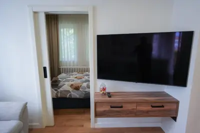 a living room with a flat screen tv on a wall at Stan na dan Bulevar in Belgrade