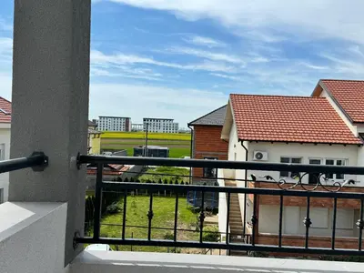 a balcony with a view of a field and buildings at Deluxe Double Room Belgrade Airport in Surčin