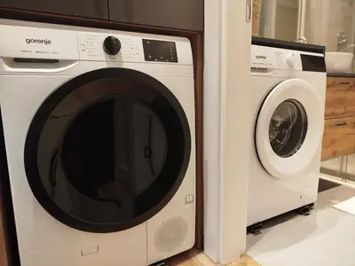 a washing machine and a dryer in a kitchen at Tiny Nest - Sava Center, Belgrade in Belgrade