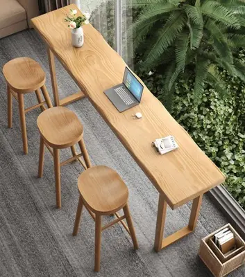 a wooden table with a laptop and two stools at Belgrade Airport luxury 2 room in Surčin