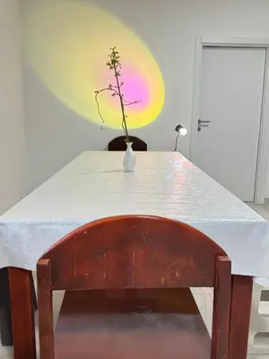 a white table with a vase with a plant in it at Belgrade Airport luxury 2 room in Surčin