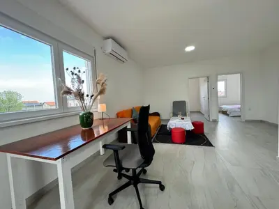 a home office with a desk and a chair at Belgrade Airport luxury 2 room in Surčin