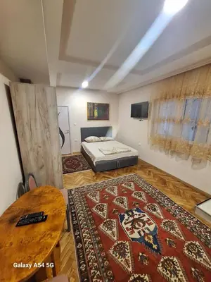 a room with a bed and a table and a rug at Dream 8 in Belgrade