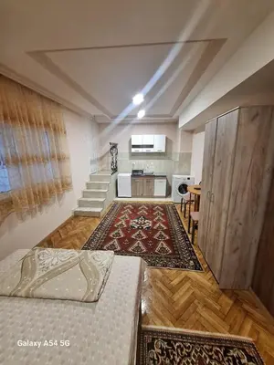 a room with a bed and a kitchen and stairs at Dream 8 in Belgrade