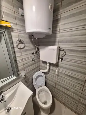 a small bathroom with a toilet and a sink at Dream 8 in Belgrade