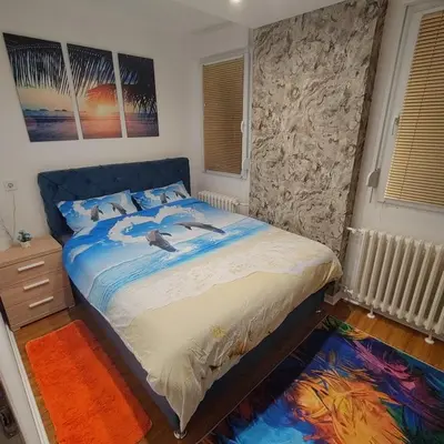 a bedroom with a bed with birds on it at Aleksandar Residence in Belgrade