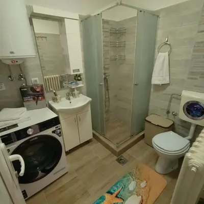 a bathroom with a shower and a toilet and a sink at Aleksandar Residence in Belgrade