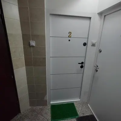 a bathroom with a white door and a shower at Aleksandar Residence in Belgrade
