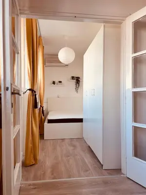 a small bedroom with a bed and a window at Your cozy place! in Belgrade