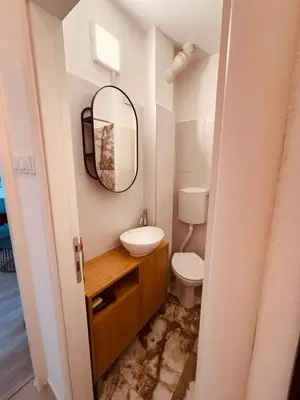a bathroom with a sink and a mirror at Your cozy place! in Belgrade