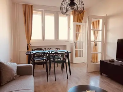 a living room with a dining room table and chairs at Your cozy place! in Belgrade