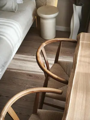 a bedroom with a bed and a wooden chair at Rossa & Bayo Apartments in Belgrade