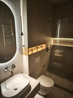 a bathroom with a sink and a toilet and a mirror at Rossa & Bayo Apartments in Belgrade