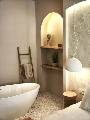 a bathroom with a white tub and a bed at Rossa & Bayo Apartments in Belgrade