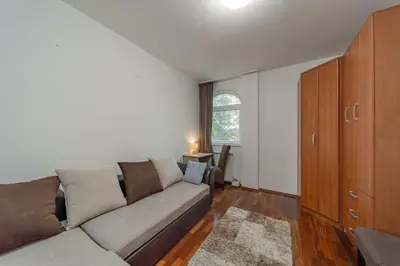 a living room with a couch and a window at Apartman Igor 1 in Belgrade