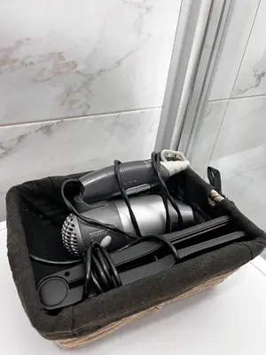 a hair dryer in a black bag on a counter at Galerija apartman in Arandjelovac