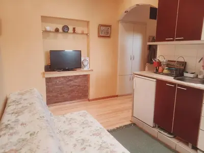 a kitchen with a sink and a tv in it at Marsala Family B&B in Belgrade