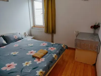 a bedroom with a blue bed with flowers on it at Marsala Family B&B in Belgrade