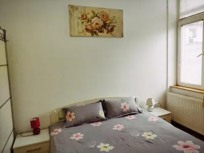 a bedroom with a bed with flowers on it at Marsala Family B&B in Belgrade