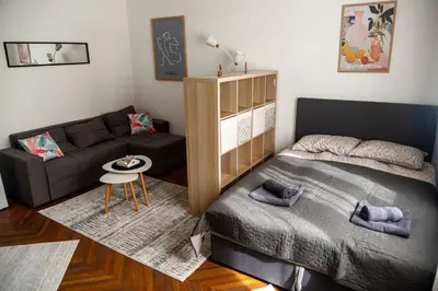 a small bedroom with a bed and a couch at Obilicev venac DM in Belgrade