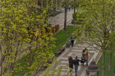 a group of people walking in a park at Obilicev venac DM in Belgrade