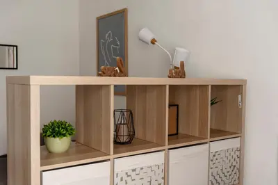a wooden book shelf in a living room at Obilicev venac DM in Belgrade