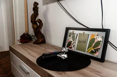 a table with a picture and a remote control on it at Obilicev venac DM in Belgrade