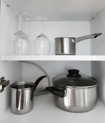 a kitchen with pots and pans on a shelf at Apartment Endorfin - Modern apartment close to airport in Surčin
