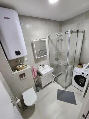 a bathroom with a shower and a toilet and a sink at Apartment Endorfin - Modern apartment close to airport in Surčin