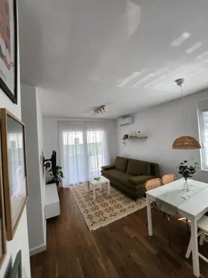 a living room with a couch and a table at Apartment Endorfin - Modern apartment close to airport in Surčin