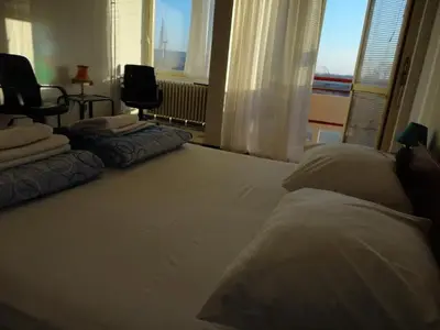 a bedroom with a large bed and a window at Belgrade Serbia apartment in Belgrade