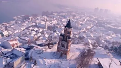 a city covered in snow with a building at Belgrade Serbia apartment in Belgrade