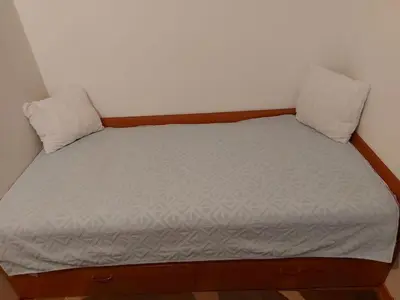 a small bed in a room with two pillows at Belgrade Serbia apartment in Belgrade