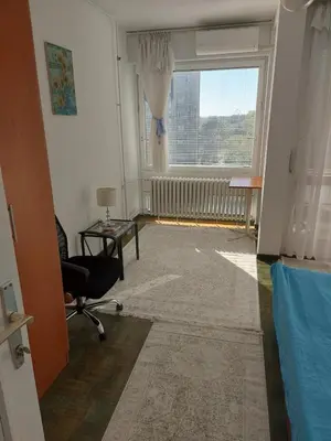 a room with a window and a chair and a desk at Belgrade Serbia apartment in Belgrade