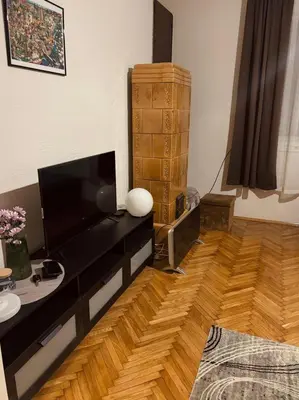a living room with a television and a wooden floor at Old town Belgrade in Belgrade