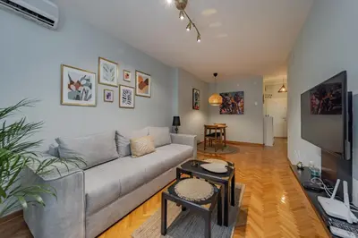 a living room with a couch and a tv at Charming One Bedroom In The Heart of Belgrade in Belgrade
