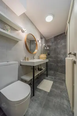 a bathroom with a toilet and a sink and a mirror at Charming One Bedroom In The Heart of Belgrade in Belgrade