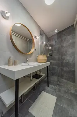 a bathroom with a sink and a mirror at Charming One Bedroom In The Heart of Belgrade in Belgrade
