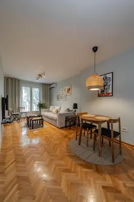 a living room with a table and a couch at Charming One Bedroom In The Heart of Belgrade in Belgrade
